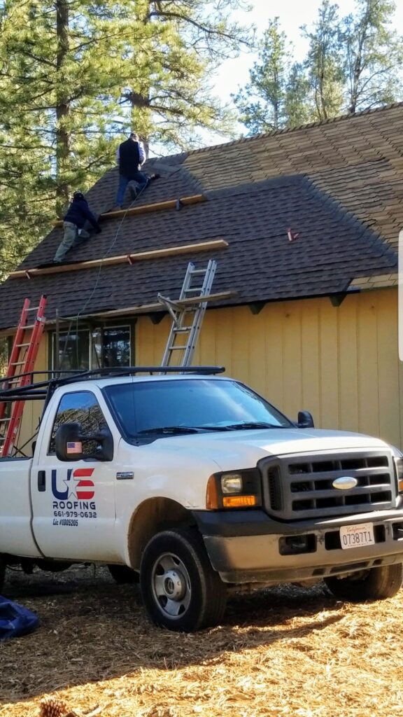 US Roofing branded truck at a roofing job site
